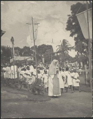 Nun leading a group of children and priests, in the Corpus Christi Procession, Vunapope Sacred Heart Mission, Kokopo, New Guinea, 1937 / Sarah Chinnery