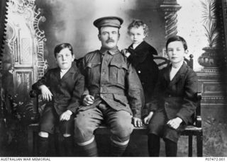 Studio portrait of 4551 Private (Pte) Thomas William Pearson, 10th Battalion, of Kadina SA, and his three sons. A farmer prior to enlistment Pte Pearson embarked on HMAT Miltiades (A28) on 7 ..