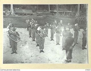 MALMAL MISSION, NEW BRITAIN. 1945-03-12. THE 11TH INFANTRY BATTALION BAND, CONDUCTED BY BANDMASTER WX29578 SERGEANT W. TUSSLER (1), PLAYS DURING THE 5TH DIVISION PROVOST COMPANY'S MARCH PAST THE ..