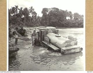 FINSCHHAFEN AREA, NEW GUINEA. 1943-11-04. A TRACTOR OF THE 2/3RD AUSTRALIAN FIELD COMPANY, ROYAL AUSTRALIAN ENGINEERS PULLING A WATER CART OUT OF THE BUMI RIVER