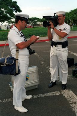 Members of Fleet Imaging Command Pacific check their equipment before covering Remembrance Day ceremonies commemorating the 50th anniversary of the Dec. 7, 1941, attack on Pearl Harbor