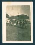 Leo Brown[?] standing with New Guineans in front of aircraft, New Guinea, c1932 to 1933