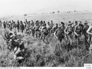 NEW GUINEA. 8 NOVEMBER 1943. A PAPUAN INFANTRY BATTALION PATROL LED BY AUSTRALIAN SOLDIERS SETS OUT INTO THE MOUNTAINS FROM KUMBARUM, BELOW SHAGGY RIDGE. THE AUSTRALIANS LEADING THE PATROL, FROM ..