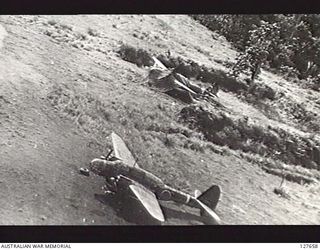 BUT, NEW GUINEA. 1943-09-27. DISPERSED JAPANESE AIRCRAFT AT THE AERODROME