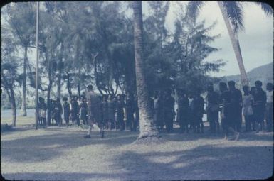 Meeting of village policemen and Patrol Officer, Peter Gall, to explain anti-malaria house-spraying campaign, crowd view : D'Entrecasteaux Islands, Papua New Guinea, 1956-1959 / Terence and Margaret Spencer