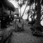 Dismantled outrigger canoe hull at lagoon shore