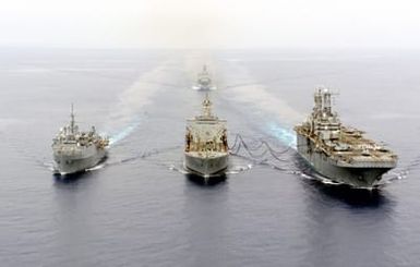 The USS SAIPAN (LHA 2) (right) conducts an Underway Replenishment (UR), with the USNS LEROY GRUMMAN (TAO 194) (center) and the USS AUSTIN (LPD 4) as USS ASHLAND (LSD 48) brings up the rear while acting as plane guard