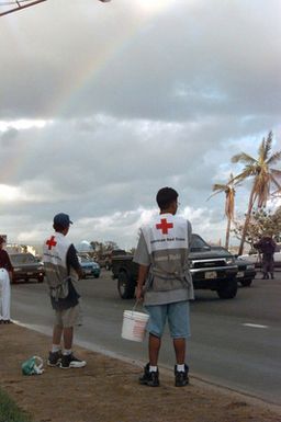 Red Cross volunteers create a pot of gold at the end of the rainbow by collecting donations along Marine Drive in Agana, Guam, during morning rush hour to help victims of Super Typhoon Paka