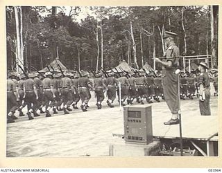 TOROKINA, BOUGAINVILLE, SOLOMON ISLANDS. 1944-12-15. MAJOR GENERAL W. BRIDGEFORD, GENERAL OFFICER COMMANDING 3 DIVISION, (1), TAKING THE SALUTE FROM B COMPANY, 47 INFANTRY BATTALION, 29 INFANTRY ..