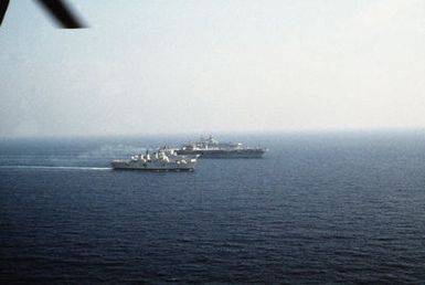 Ships from four nations sail in formation during the NATO Southern Region exercise DRAGON HAMMER '90. The ships are, from front: the British light aircraft carrier HMS INVINCIBLE (R-05), the Italian light aircraft carrier ITS GIUSEPPE GARIBALDI (C-551, the nuclear-powered aircraft carrier USS DWIGHT D. EISENHOWER (CVN 69), the Spanish aircraft carrier SPS PRINCIPE DE ASTURIAS (R-11) and the amphibious assault ship USS SAIPAN (LHA 2)