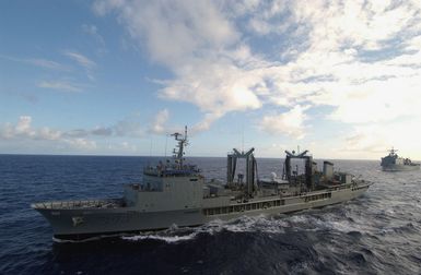 Port bow view of the Royal Australian Navy (RAN) DURANCE CLASS: Underway Replenishment Tanker, Her Majestys Australian Ship (HMAS) SUCCESS (OR 304), underway in the Pacific Ocean, during a Replenishment At Sea (RAS), conducted in support of Exercise RIMPAC 2004. The US Navy (USN) Amphibious Assault Ship, USS TARAWA (LAH 1) is underway in the background. RIMPAC is the largest international maritime exercise conducted in the waters around the Hawaiian Islands, and is designed to enhance the tactical proficiency of participating units in a wide array of combined operations at sea, while enhancing stability in the Pacific Rim region