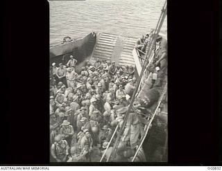 MOMOTE, LOS NEGROS ISLAND, ADMIRALTY ISLANDS. 1944-03-18. RAAF REINFORCEMENTS, TOGETHER WITH AMERICAN TROOPS, WAITING TO GO ASHORE FROM A LANDING CRAFT TANK