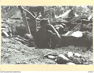 TSIMBA RIDGE, BOUGAINVILLE ISLAND. 1945-02-06. A MORTAR CREW OF THE 101ST BRIGADE SUPPORT COMPANY IN ACTION WHILE SUPPORTING AN ATTACK ON ENEMY POSITIONS BY THE 31/51ST INFANTRY BATTALION