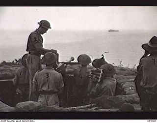 MOROBE, NEW GUINEA. 1943-08-13. PRACTICE SHOOT OF THE 40MM BOFORS GUN L3, 162 AUSTRALIAN LIGHT ANTI-AIRCRAFT BATTERY. LEFT TO RIGHT:- QX40370 BOMBARDIER J. W. CHARLES; QX32578 GUNNER L. J. FREY; ..