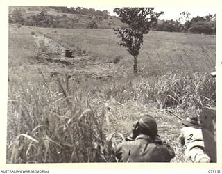 GUSIKA, NEW GUINEA. 1944-03-15. MEMBERS OF THE 1ST TANK BATTALION USING THE "BOYES" TANK ATTACK RIFLE TO TEST THE VULNERABILITY OF AN ALL ROUND VISION CUPOLA FITTED TO THE BODY OF A MATILDA TANK