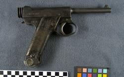 Japanese Nambu semi-automatic pistol and ammunition magazine