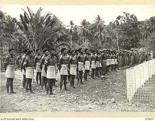 FINSCHHAFEN, NEW GUINEA, 1944-02-29. MEMBERS OF "C" COMPANY, PAPUAN INFANTRY BATTALION UNDER COMMAND OF NX86595 LIEUTENANT G.D. MACFARLANE, AND AUSTRALIAN 9TH DIVISION REPRESENTATIVES AT THE ..