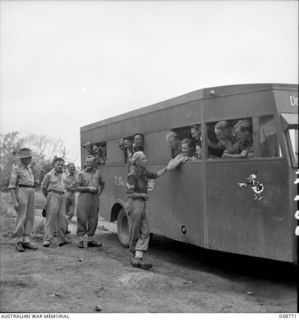 POMPOM VALLEY, NEW GUINEA. 1943-10-26. MEMBERS OF THE 7TH AUSTRALIAN DIVISION CONCERT PARTY BOARDING THEIR BUS TO GO TO THE SITE OF THIS NIGHT'S ENTERTAINMENT. SHOWN ARE:- SX1552 SERGEANT (SGT) A. ..