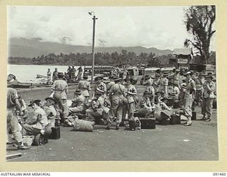 LAE, NEW GUINEA, 1945-05-07. AWAS PERSONNEL ON THE BEACH AT MILFORD HAVEN WAITING FOR TRANSPORT TO TAKE THEM TO THE AWAS BARRACKS ON BUTIBUM ROAD. THEY ARE PART OF A GROUP OF 342 AWAS WHO CAME FROM ..