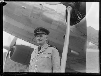 Flying Officer J D Campbell, ex RNZAF, beside an aircraft, Rarotonga, Cook Islands