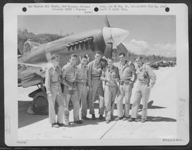 A Group Of Pilots From The First Curtiss P-40S To Land On Munda, New Georgia Island, Solomon Islands, Pose In Front Of One Of The Planes. They Are, Left To Right: Lt. K.M. Nzus; Lt. R.M. Magown; Lt. R.B. Walker; Capt. T.B. Jennings; Lt. F.C. Crain; Capt (U.S. Air Force Number 80202AC)