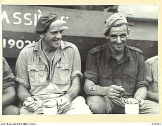 TOROKINA, BOUGAINVILLE, SOLOMON ISLANDS. 1945-03-14. MEMBERS OF THE 2/4TH ARMOURED REGIMENT AUSTRALIAN ARMOURED CORPS EATING ICE CREAM (NORMALLY ONLY SUPPLIED TO HOSPITAL PATIENTS). SX14253 TROOPER ..