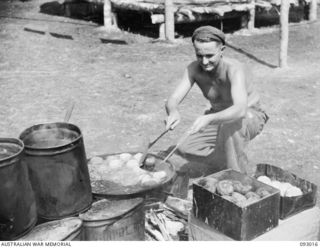 MOROKAIMORO, BOUGAINVILLE, 1945-06-06. CPL L.M. REID, 2/8 COMMANDO SQUADRON, COOKING RISSOLES AT THE CAMP