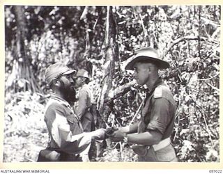 LIEUTENANT COLONEL R. MINOBE, JAPANESE MEDICAL OFFICER (1) HANDING HIS SWORD TO LIEUTENANT COLONEL W.A. RUSSELL, COMMANDING OFFICER 8 FIELD AMBULANCE (2), A MEMBER OF THE AUSTRALIAN SURRENDER PARTY ..