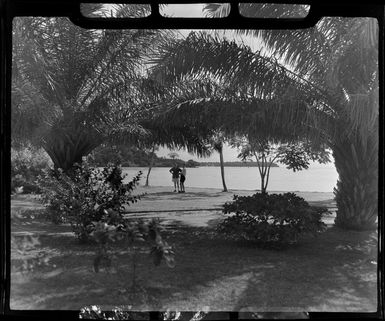 Tropique Hotel, Tahiti, shows unidentified men talking surrounded by native plants and trees