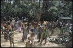 Ritual exchange: young women wearing feather valuables and other wealth items, observing ritual exchange of pork and other food