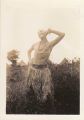 Soldier poses while wearing a grass skirt, South Pacific, 1940s