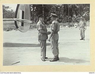 AITAPE, NEW GUINEA. 1945-03-19. GENERAL SIR THOMAS A. BLAMEY, COMMANDER-IN-CHIEF, ALLIED LAND FORCES, SOUTH WEST PACIFIC AREA (1), SHAKING HANDS WITH MAJOR-GENERAL J.E.S. STEVENS, GENERAL OFFICER ..