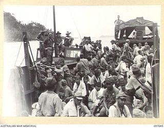 FAURO ISLAND, BOUGAINVILLE AREA. 1945-10-01. AN AUSTRALIAN LANDING CRAFT LOADED WITH JAPANESE PATIENTS AND GEAR. ALL JAPANESE MEDICAL CASES FROM THE BUIN AREA ARE BEING EVACUATED TO THE NEWLY ..