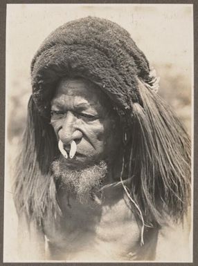 Types from Buna District [old man with beard wearing head dress] Frank Hurley