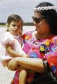 Federated States of Micronesia, woman holding child at airport on Pohnpei Island