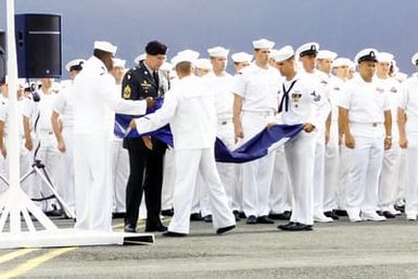 A designated flag detail of USN Sailors folds the Admirals Flag for outgoing Commander-in-CHIEF US Pacific Command Admiral Dennis C. Blair during the Change of Command Ceremony for the Commander-in-CHIEF US Pacific Command at Marine Corps Base, Kaneohe Bay, Hawaii. During the Ceremony Admiral Dennis C. Blair relinquished his command to Admiral Thomas B. Fargo