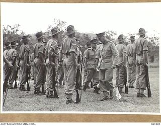 17 MILE, PORT MORESBY AREA. 1943-12-24. VX247 BRIGADIER C. A. STINSON, DEPUTY DIRECTOR OF ORDNANCE SERVICES, HEADQUARTERS, NEW GUINEA FORCE (1), INSPECTS THE TROOPS OF THE 10TH AUSTRALIAN ADVANCED ..