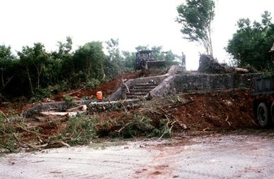 In preparation for next year's observation of the 50th anniversary of Guam's World War Two liberation, Seabees from Naval Mobile Construction Battalion 3 (NMCB-3) clear a historic area at Orote Point, Naval Station Guam. The rock staircase was built near Sumay by Japanese prisoners of war in 1944-46 after American forces had recaptured the island in July of 1944. The prisoners dedicated the stairway to the Emperor of Imperial Japan Hirohito