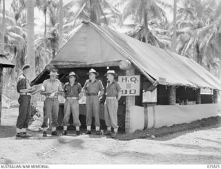 SIAR, NEW GUINEA. 1944-09-11. THE CAMP ORDERLY ROOM AND MEMBERS OF THE STAFF OF THE 113TH BRIGADE WORKSHOPS. IDENTIFIED PERSONNEL ARE:- VX280 MAJOR D.V. GOLAND, COMMANDING OFFICER (1); NX79114 ..