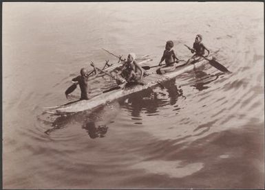 Four men from Santa Cruz in a canoe for trade with Southern Cross passengers, Santa Cruz Islands, 1906 / J.W. Beattie