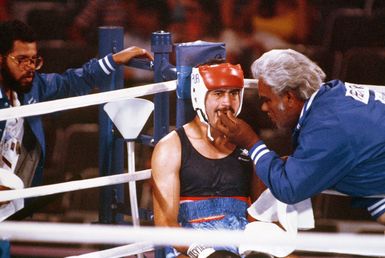 Army SPECIALIST 4 Aristides Gonzalez, from Fort Bragg, North Carolina, receives advice from his coach during a fight with Paulo Tuvale of Samoa at the 1984 Summer Olympics. Gonzalez is representing Puerto Rico