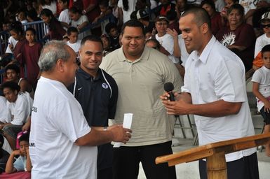 Earthquake ^ Flooding ^ Tsunami - Tafuna, American Samoa, November 28, 2009 -- At halftime in a high school football championship, three American Samoan NFL football players presented $50,000 to the American Samoan Red Cross because of the recent earthquake and tsunami disaster. Vaitoa Hans A. Langkilde, a board member of the local Red Cross, left, received the envelope from Gabe Reid, a former tight end for the Chicago Bears, right. Looking on are Reno Mahe, former Philadelphia Eagles running back, next to Langkilde, and Fa'a Ifo Pili, former Philadelphia Eagles lineman. Richard O'Reilly/FEMA