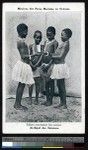Four children looking at a picture, Solomon Islands, ca.1900-1930