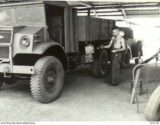 PORT MORESBY, NEW GUINEA. 1944-04-10. VX67184 CRAFTSMAN K. NORMAN SPRAYING A FRESH COAT OF PAINT ON A THREE TON CHEVROLET TRUCK AT THE 11TH ADVANCED WORKSHOP, AUSTRALIAN ELECTRICAL AND MECHANICAL ..