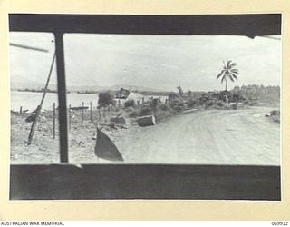 MILNE BAY, NEW GUINEA. 1943-01. A VIEW, TAKEN THROUGH THE WINDSCREEN OF A JEEP, NEAR GILI GILI. THE CARGO STEAMER, "ANSHUN", WHICH WAS BY A JAPANESE CRUISER ON THE 1942-09-05, DURING THE BATTLE FOR ..