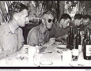 LAE, NEW GUINEA, 1945-12-25. MEMBERS OF FIRST ARMY ENJOYING THEIR CHRISTMAS DINNER IN THE NO 1 OTHER RANKS' MESS