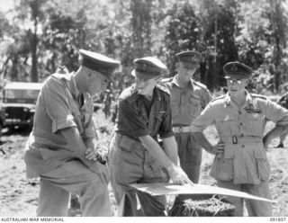 BOUGAINVILLE, 1945-05-12. LT-GEN V.A.H. STURDEE, GOC FIRST ARMY (1), HAS ENEMY POSITIONS EXPLAINED TO HIM ON THE MAP BY BRIG H.H. HAMMER, COMD 15 INFANTRY BRIGADE (2), DURING HIS VISIT TO HQ 15 ..