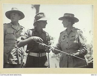 BOUGAINVILLE. 1945-03-31. LADY WAKEHURST (3), AND LIEUTENANT-COLONEL B.J. CALLINAN COMMANDING OFFICER, 26 INFANTRY BRIGADE, EXAMINING A JAPANESE SWORD CAPTURED IN NORTH BOUGAINVILLE. LADY ..