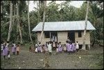 Women and children near a house