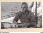 TOROKINA, BOUGAINVILLE, 1945-07-16. LT-COL D. ZACHARIN, COMMANDING OFFICER, 106 CASUALTY CLEARING STATION, WORKING IN HIS OFFICE